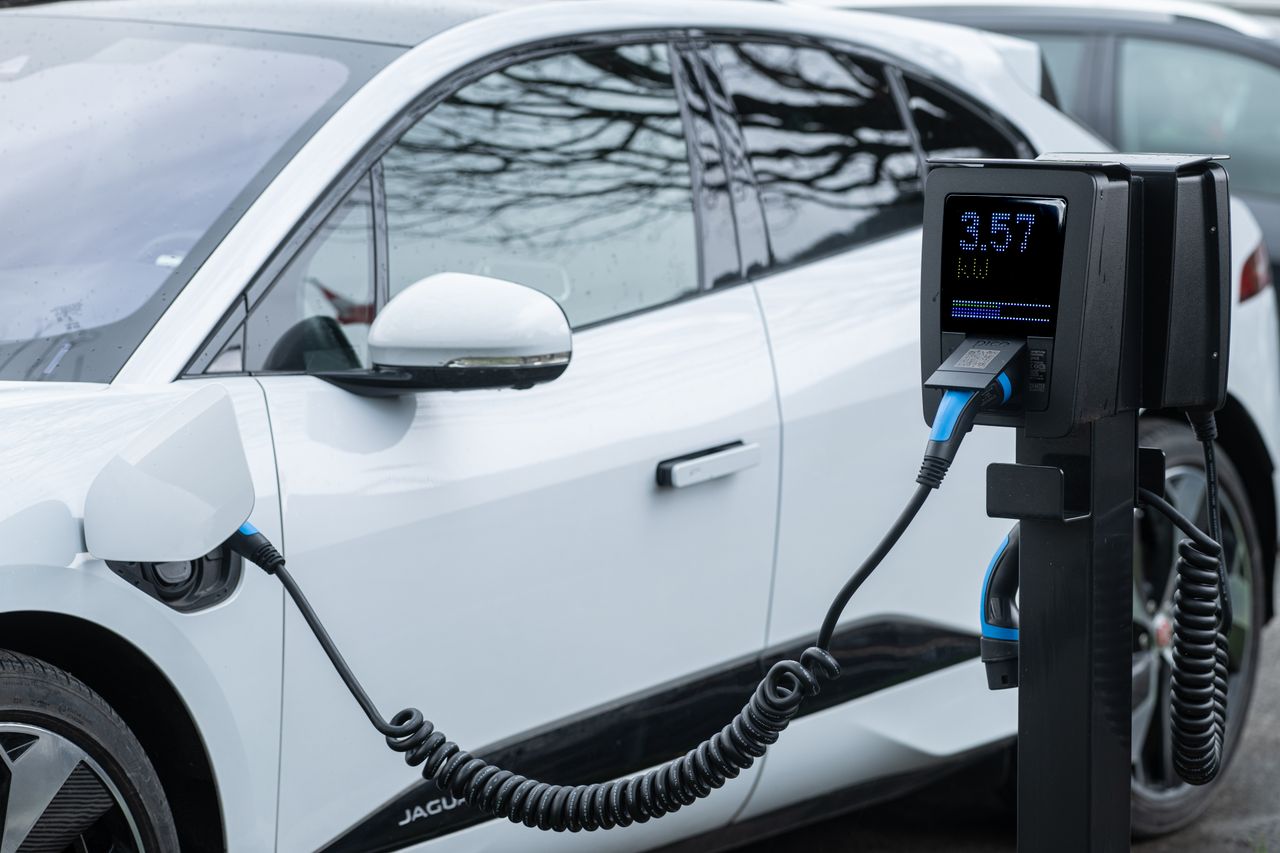 Services Close-up of an electric vehicle charging at a station, showcasing energy-efficient technology.